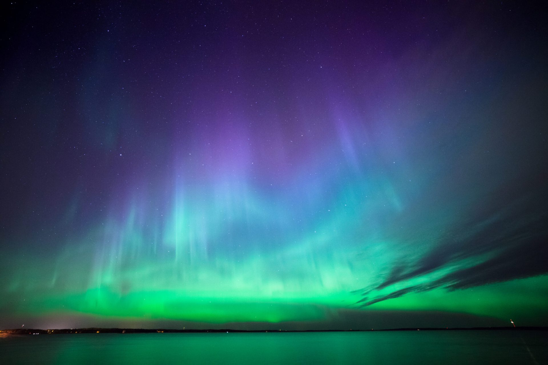 Northern Lights dancing over the Arctic landscape of Tromsø, Norway, during the 2026/2027 Aurora season.